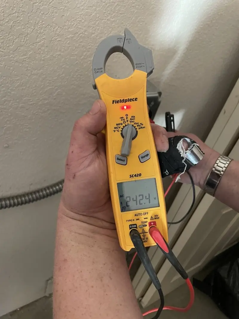 Voltage testing with clamp meter during Whole House Surge Protector in Clarks Summit